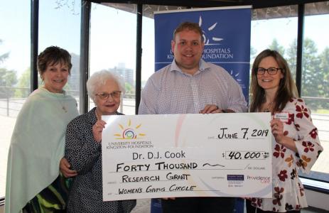 Dr DJ Cook, Neurosurgeon at KHSC holds cheque for $40,000 research grant