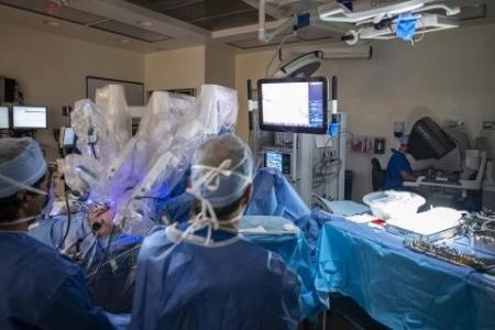 Dr. Patel (background) and team (foreground) complete a robotic procedure at our KGH site.