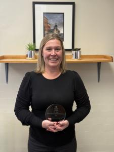 Kim Lloyd holding her 2024 Quality Improvement/Innovation Award 